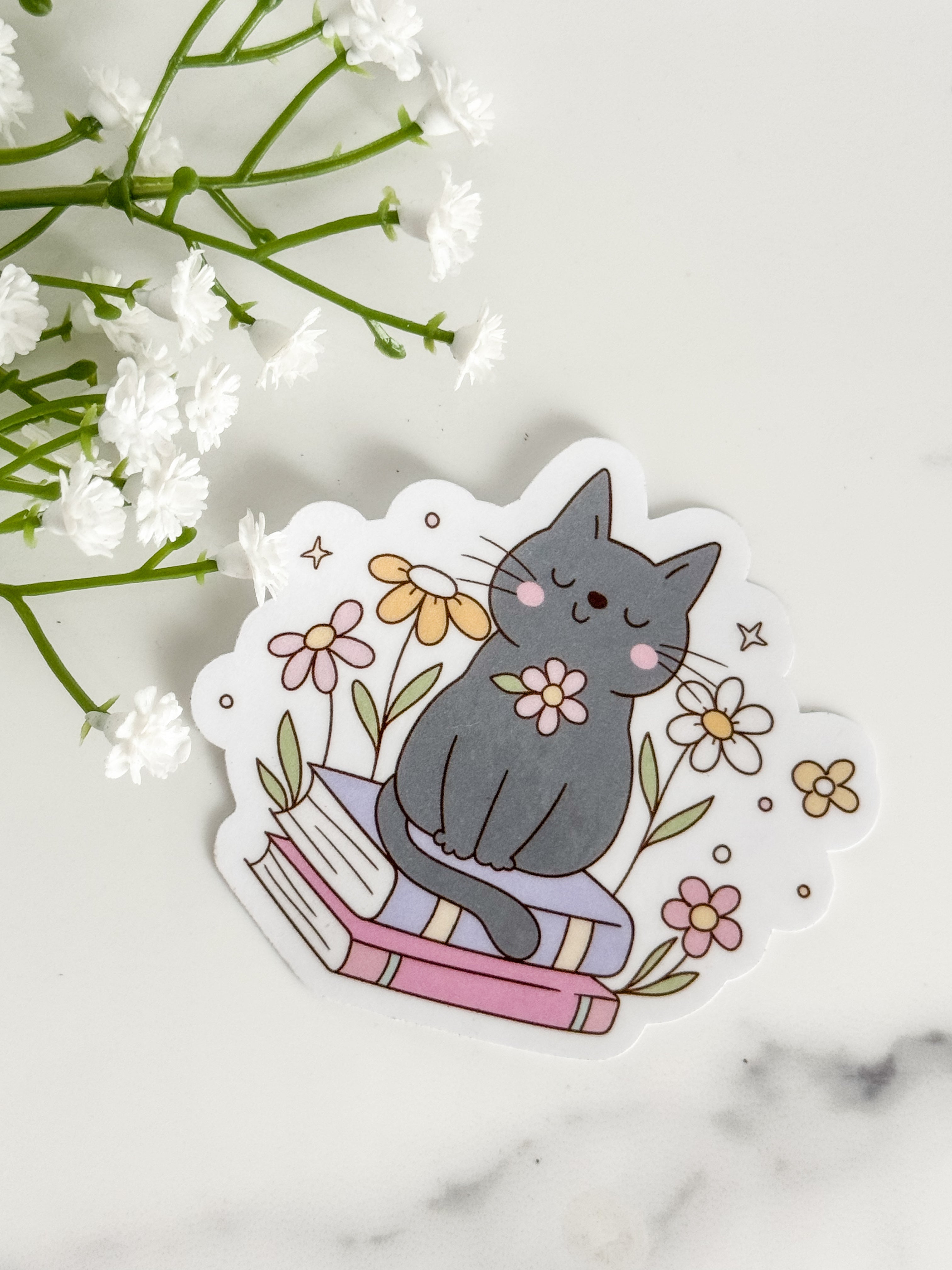 Cat Sitting On Books Sticker