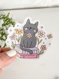Cat Sitting On Books Sticker